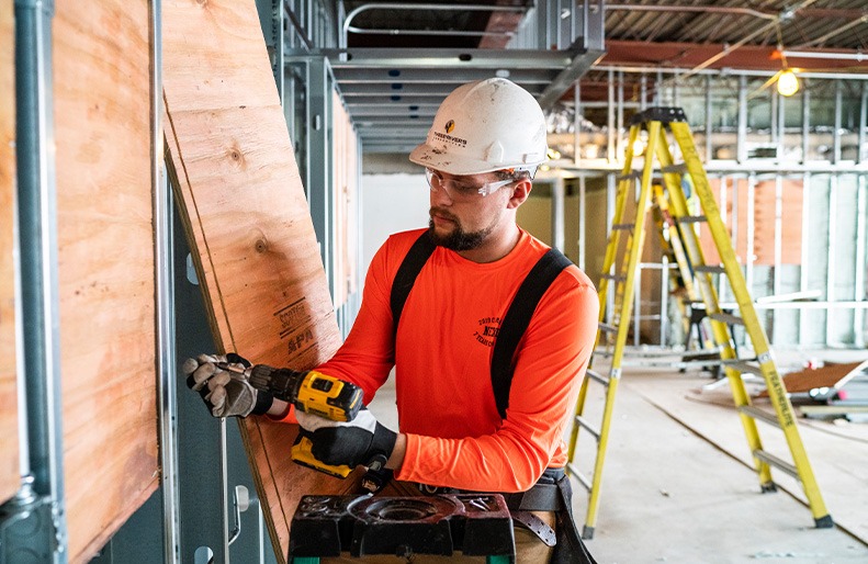 A Three Rivers employee works in the field.