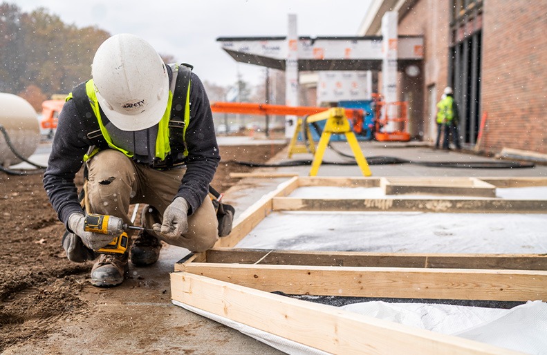 A Three Rivers employee works in the field.