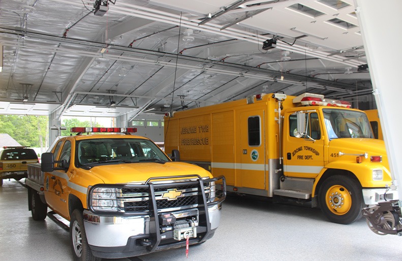 Two fire rescue vehicles stationed inside the Jerome Township Fire Department.